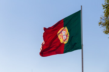 Portugal flag on the blue clear sky