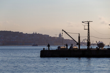 Fototapeta premium silhouette of fishermen in the morning, Portugal