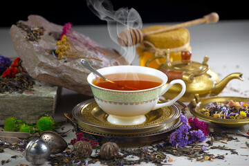 Hot sweet tea in a cup on old background