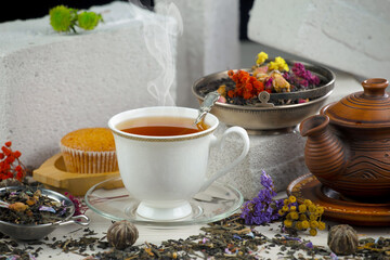 Hot sweet tea in a cup on old background