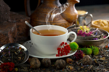 Hot sweet tea in a cup on old background