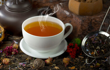 Dry tea leaves in a spoon on an old background