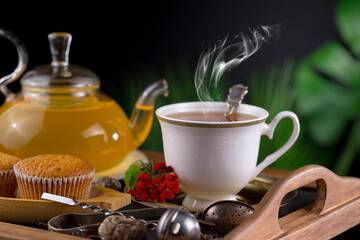 Dry tea leaves in a spoon on an old background