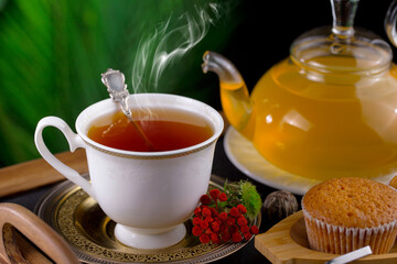 Sweet, hot tea with dessert, on an old background.
