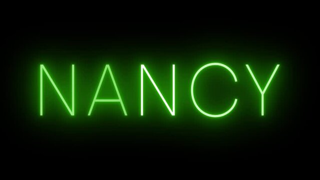 Flickering green retro style neon sign glowing against a black background