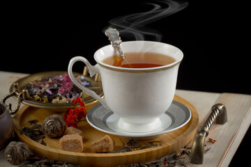 Sweet, hot tea with dessert, on an old background.