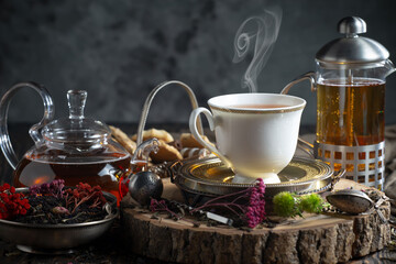 Hot sweet tea in a cup on old background
