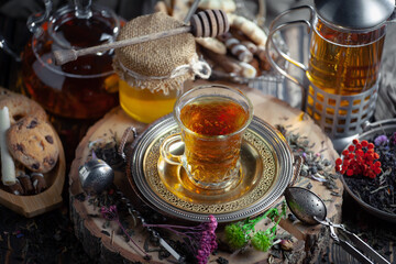 Dry tea leaves in a spoon on an old background