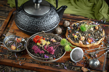 Dried tea leaves in a spoon, on an old background.