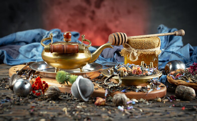 Dried tea leaves in a spoon, on an old background.