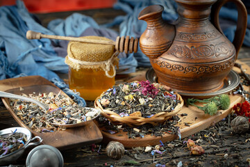 Dried tea leaves in a spoon, on an old background.