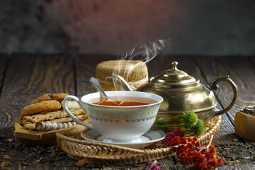 Sweet, hot tea with dessert, on an old background.