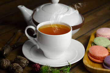 Sweet, hot tea with dessert, on an old background.