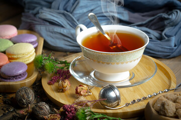 Sweet, hot tea with dessert, on an old background.