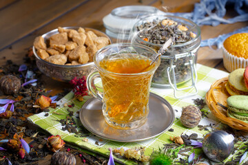 Sweet, hot tea with dessert, on an old background.