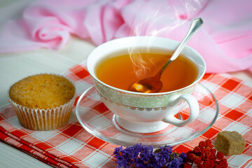 Sweet, hot tea with dessert, on an old background.