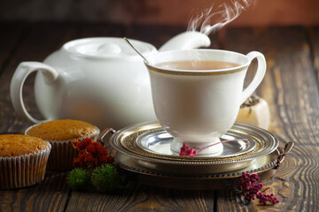 Sweet, hot tea with dessert, on an old background.