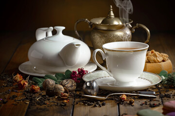 Sweet, hot tea with dessert, on an old background.