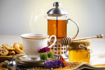 Sweet, hot tea with dessert, on an old background.