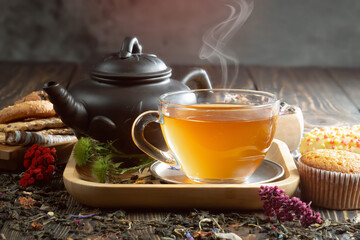 Hot sweet tea in a cup on old background