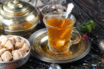 Hot sweet tea in a cup on old background