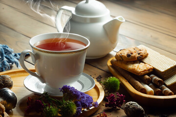 Hot sweet tea in a cup on old background