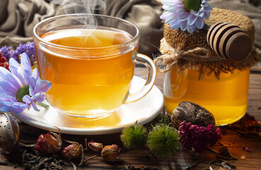 Hot sweet tea in a cup on old background