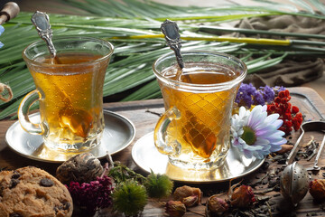 Hot sweet tea in a cup on old background