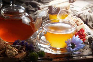 Tafelkleed Sweet, hot tea with dessert, on an old background. © Karnav