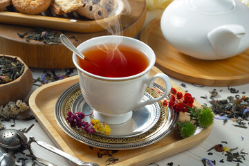 Sweet, hot tea with dessert, on an old background.