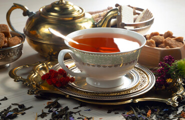 Sweet, hot tea with dessert, on an old background.