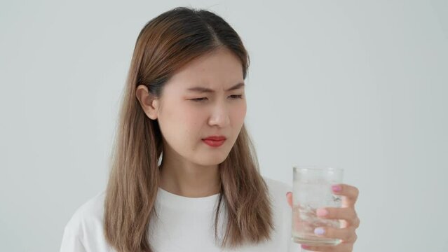 Asian woman feel sensitive teeth after drinking cold, female suffer tooth, decay problems, dental care, tooth extraction, decay problem, bad breath, Gingival Recession, Oral Hygiene instruction