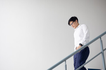 Asian office worker walk step down on stairs when achievement job corporate.