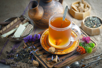 Sweet, hot tea with dessert, on an old background.