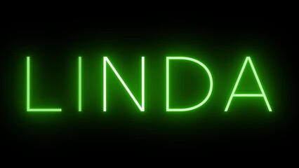 Flickering green retro style neon sign glowing against a black background