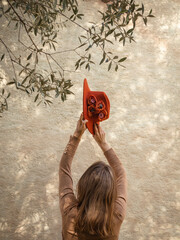 woman playing with a red hat