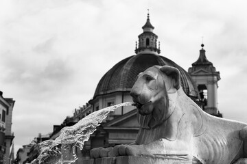 Detail of the Fountain of the Lions in Piazza del Popolo in Rome, jet of water and in the...
