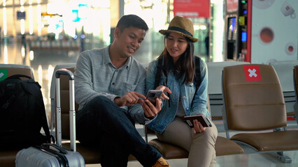 Couple traveler sitting and relax in the terminal airport.