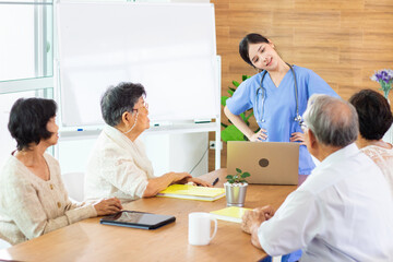 Nursing Home Care concept. A group of elderly people in nursing homes meeting with nursing care assistants