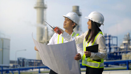 Two industrial engineer working near the electrical plant.