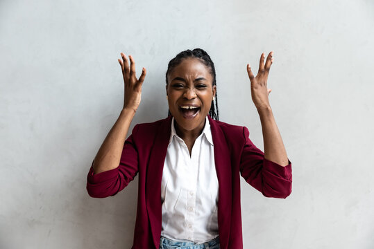 Young angry African American business woman, employer, senior manager rages about unfinished business loss of earnings, dismissal or racist comments at work with insults based on skin color and race