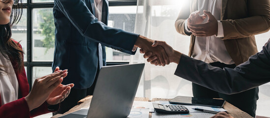 Business people shaking hands, finishing up meeting, business etiquette, congratulation, merger and acquisition concept.