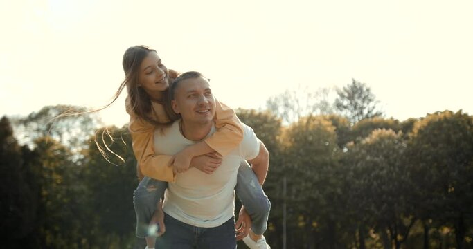 Father with daughter piggyback in autumn park