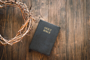 Crown thorns and holy bible or book on a wood background, copy space. Concept for faith,...