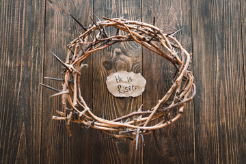 He is Risen. Jesus Crown Thorns and nails and cross on a wood background. Crucifixion Of Jesus Christ. Passion Of Jesus Christ. Concept for faith, spirituality and religion. Easter Day