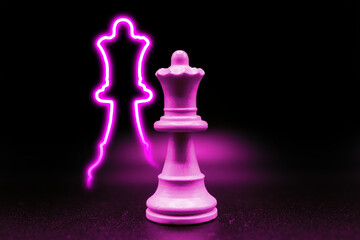 purple pink violet queen with led in the shape of a queen piece. close up photo with black...