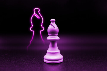 purple pink violet bishop with led in the shape of a bishop. close up photo with black background. chess piece illustration