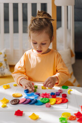 A little girl play with plasticine and colorful numbers.  Learning to count through play. Early education. Fine motor skills, creativity and  hobby.