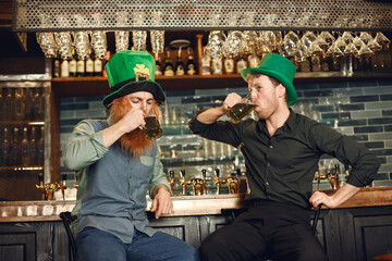 Men celebrate St. Patrick's Day at bar with a mug of beer