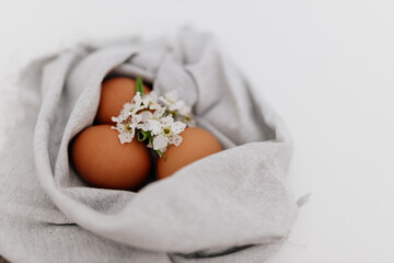 Fototapeta na wymiar Easter still life on white background, painted red eggs in linen napkin. Mock up for spring card
